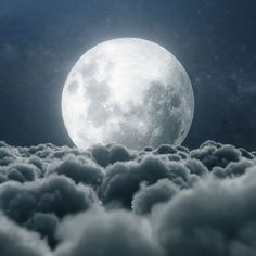 the full moon is shining above some clouds