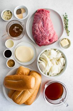 an assortment of meats and sauces on plates