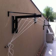 an image of a kite that is tied up to the side of a building with wires hanging from it