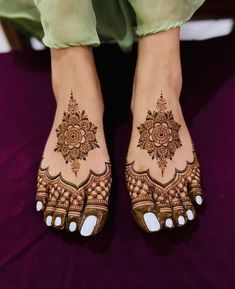 the feet are decorated with henna and flowers