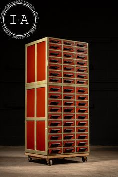 a large red cabinet with lots of drawers on it