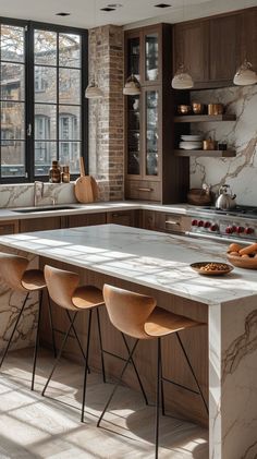 a kitchen with marble counter tops and wooden chairs