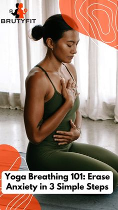 a woman sitting on the floor with her stomach exposed and holding her hand up to her chest