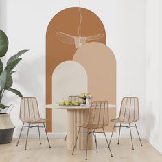 a dining table with chairs and a plant in front of it