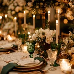 the table is set with candles and flowers