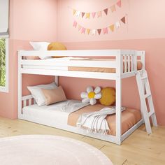 a white bunk bed sitting next to a pink wall