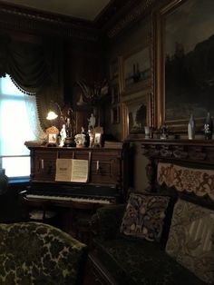 a living room filled with furniture and a piano