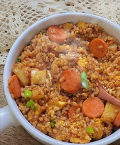 a white bowl filled with rice and carrots