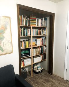 a living room with a book shelf filled with lots of books next to a door