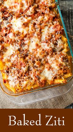 a glass casserole dish filled with meat and cheese covered in sauce, on a table