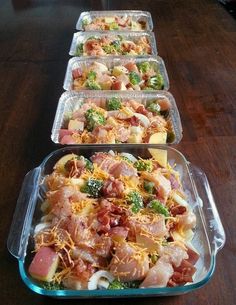 two pans filled with chicken, broccoli and bacon potato bake on top of a wooden table