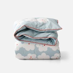 two blue and white sheets with clouds on them