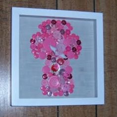 a white frame with pink buttons in it