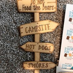 a wooden sign that says do not feed the bears campsite hot dogs smores