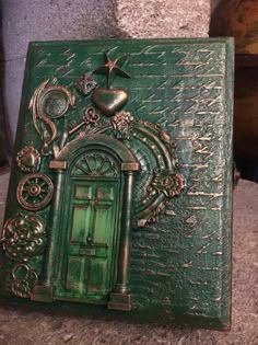 a green book with an ornate design on it's cover sitting on a table