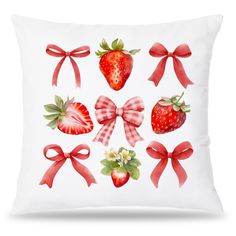 a white pillow with red bows and strawberries on the front, along with two strawberrys