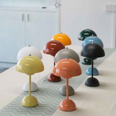 several different colored lamps are lined up on the table