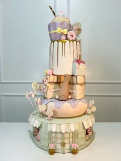 a three tiered cake with frosting and decorations