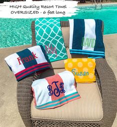 beach towels are sitting on an outdoor chair by the pool with personalized towel covers