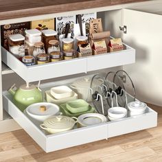 an open drawer in a kitchen filled with dishes and condiments on the bottom shelf