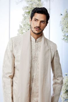 This sherwani set features all over matt sequin on a sand raw silk base. It is paired with off-white silk kurta and soften raw silk afghani salwar. Complimenting stole and footwear is also available.From Seema Gujral's Tuscan Summer collection. DELIVERY TIMEPlease allow 8-12 weeks for your outfit to arrive.FABRIC DETAILSRaw SilkProfessional cleaning only. Formal Cream Churidar With Chikankari Embroidery, Eid Cream Traditional Wear With Sheer Dupatta, Festive Cream Kurta With Sheer Dupatta, Cream Sherwani With Resham Embroidery For Eid, Eid Cream Sherwani With Resham Embroidery, Off White Sherwani For Eid, Elegant Sherwani With Sheer Dupatta For Diwali, Traditional Beige Wear With Sheer Dupatta, Beige Traditional Wear With Sheer Dupatta