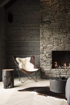 a chair sitting in front of a fire place