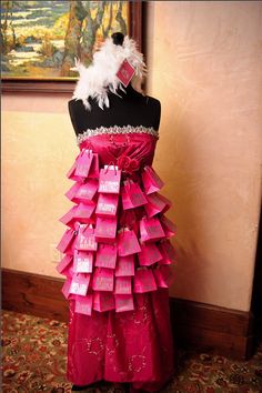 a dress made out of pink and white paper