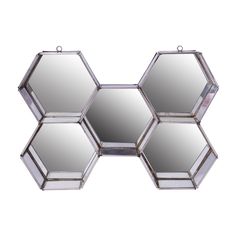 three hexagonal mirrors hanging on the wall