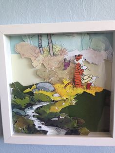 a paper cut out of winnie the pooh and tigger in a white frame