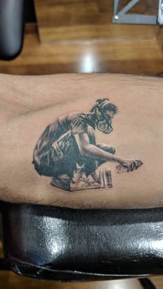 a man's arm with a tattoo of a monkey on the back of his leg