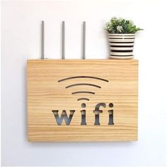 a wooden sign with the word wifi on it next to a potted plant