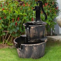 an outdoor water fountain in the grass