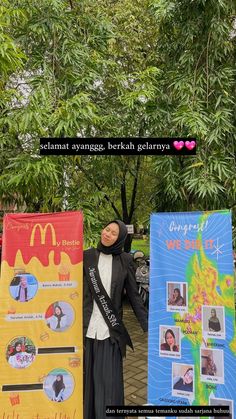 a woman standing next to two banners with pictures on them and the caption that says, selamat avangga beka gelanya