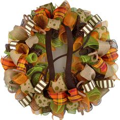 a colorful wreath with ribbons and bows on the front door for fall or halloween decor