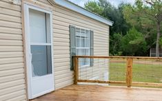 a house with a wooden deck and sliding glass doors