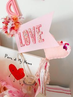 a valentine's day card with the word love on it and some decorations around it