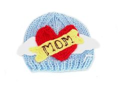 a knitted hat with the word mom written on it and a heart in the middle