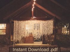 the entrance to a house is lit up at night with lights on and curtains hanging from the roof