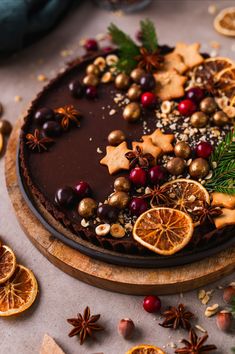 a chocolate cake decorated with orange slices and spices