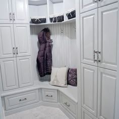 a white closet filled with lots of cupboards and pillows on top of each other