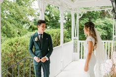 a bride and groom standing on a porch