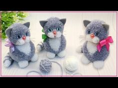 two gray and white kittens sitting next to each other with balls of yarn in front of them