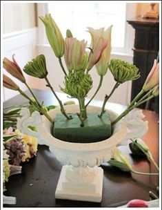 a vase with flowers in it sitting on a table