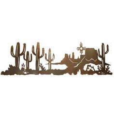 a metal wall hanging with cactus and mountains in the background