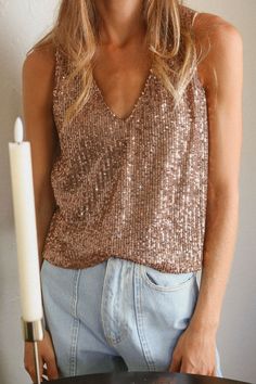 Sparkle All the Way!With shimmery and delicate sequins, this eye-catching top is ready to be worn on your next rendezvous! Makes for perfect pairing for jeans or dressier shorts, add a layer of your favorite blazer on those cooler nights. Materials & Care - Content: 95% Polyester, 5% Spandex- Care: Machine wash cold, tumble dry low, cool iron if needed- Made in the USA Size & Description -V neckline-Tank Top-Sequin-Lined-Loose Fit-Model is wearing size S Glamorous V-neck Top For Night Out, Glamorous V-neck Top For Parties, Glamorous Embellished Top For Date Night, Embellished Glamorous Top For Date Night, Trendy V-neck Party Tops, Glamorous Contrast Sequin Top For Fall, Glamorous Fall Top With Contrast Sequin, Glamorous Fall Tops With Contrast Sequin, Glamorous V-neck Tops For Date Night