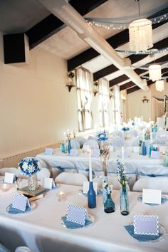 the tables are set with blue and white decorations