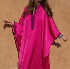 Experience the grace of Moroccan fashion with our Oversized Crepe Kaftan in the charming Pink hue. This kaftan is a masterpiece that seamlessly combines tradition and modernity, offering both style and comfort.   Product Details:      Oversized Crepe Kaftan with Handmade Embroideries : This kaftan is adorned with exquisite handmade embroideries, showcasing the artistry of Moroccan craftsmanship and adding an elegant touch to your look.     Off-White Handmade Embellishments : Delicate off-white h Elegant Pink Kaftan With Kimono Sleeves, Oversized Elegant Kaftan, Kaftan Dress Modern, Abaya Fashion Dubai, Moroccan Clothing, Modest Casual Outfits, Floral Chiffon Maxi Dress, Kaftan Designs, Mode Kimono