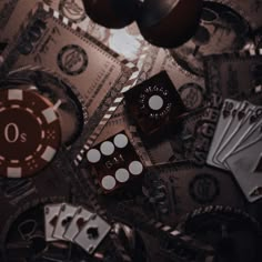 casino chips and dices are scattered on top of one another in this artistic photo