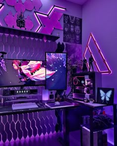 a purple room with two monitors, keyboard and mouse on the desk in front of it