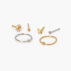 Give your nose jewelry a pop of girly touch with this must-have set! Gold and silver-tone set includes a mix of 4 different nose studs and 2 hoop nose rings. Perfect for the girl who loves butterflies and daisies! Finish: Mixed metal Size: 20G/0.8mm Closure: Stainless steel post/infinity loop Pack Size: 6 Material: Metal - Claire's Mixed Metal 20G Butterfly Daisy Mixed Nose Rings - 6 Pack Butterflies And Daisies, 18g Nose Ring, Hoop Nose Rings, Faux Nose Ring, L Shaped Nose Ring, Nose Piercing Jewelry, Nose Studs, Tongue Rings, Nose Jewelry